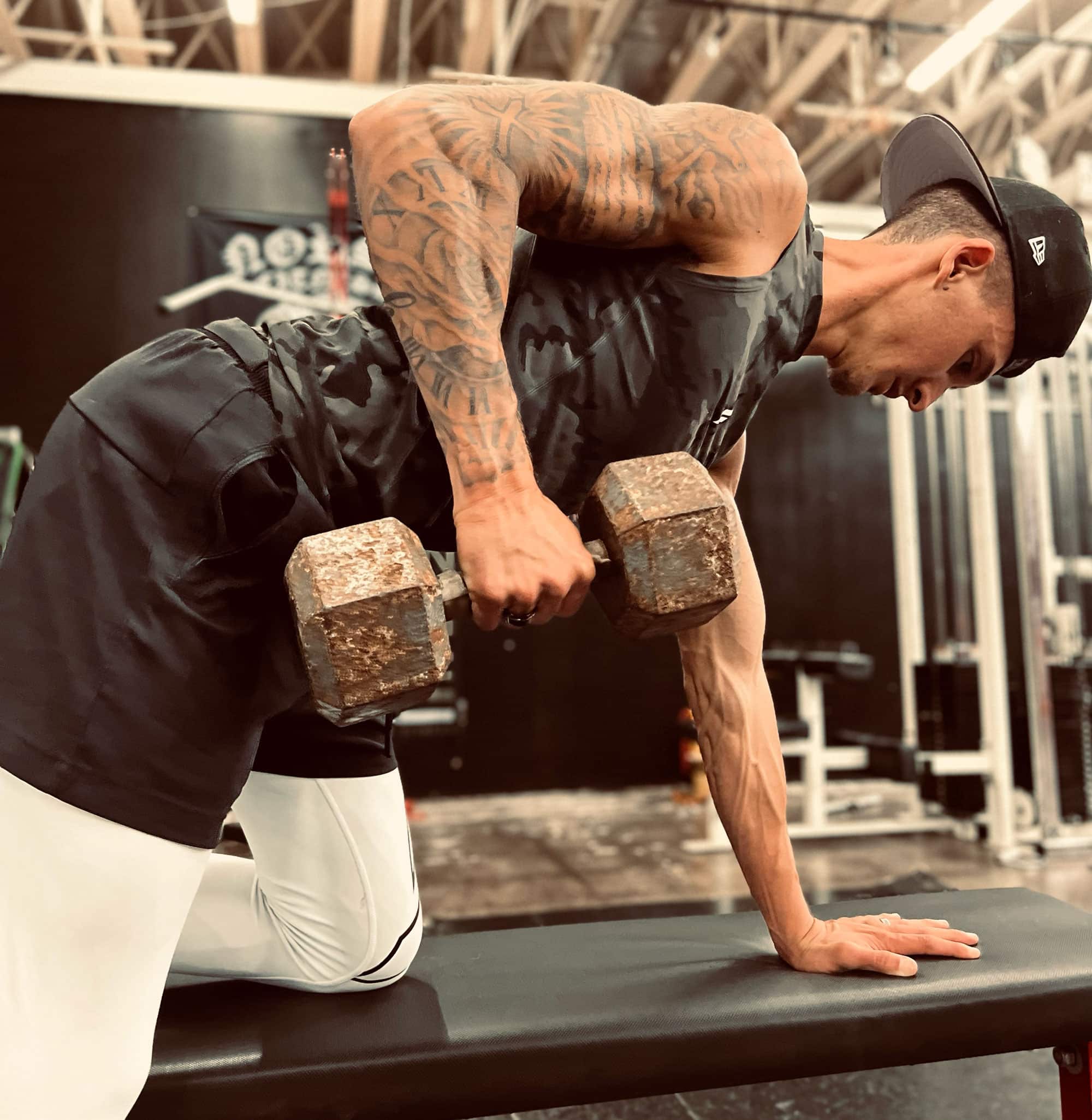 Coach Brad lifting weights at the gym on a bench press